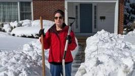 Nancy shoveling front walk